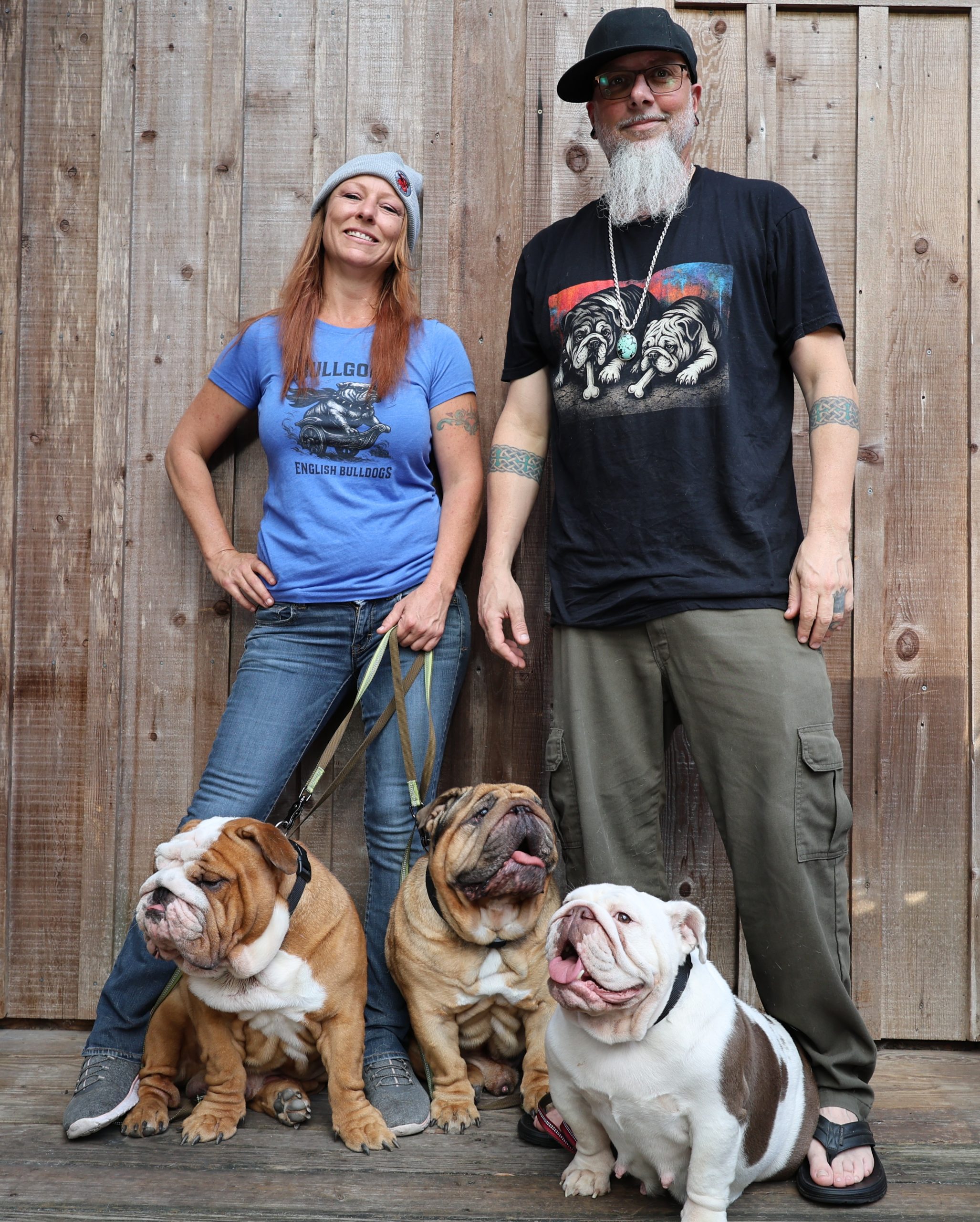 Nicole and Joshua Willett wearing Bullgodz HQ apparel alongside their English Bulldogs, showing how real dogs inspire the Bullgodz lifestyle brand
