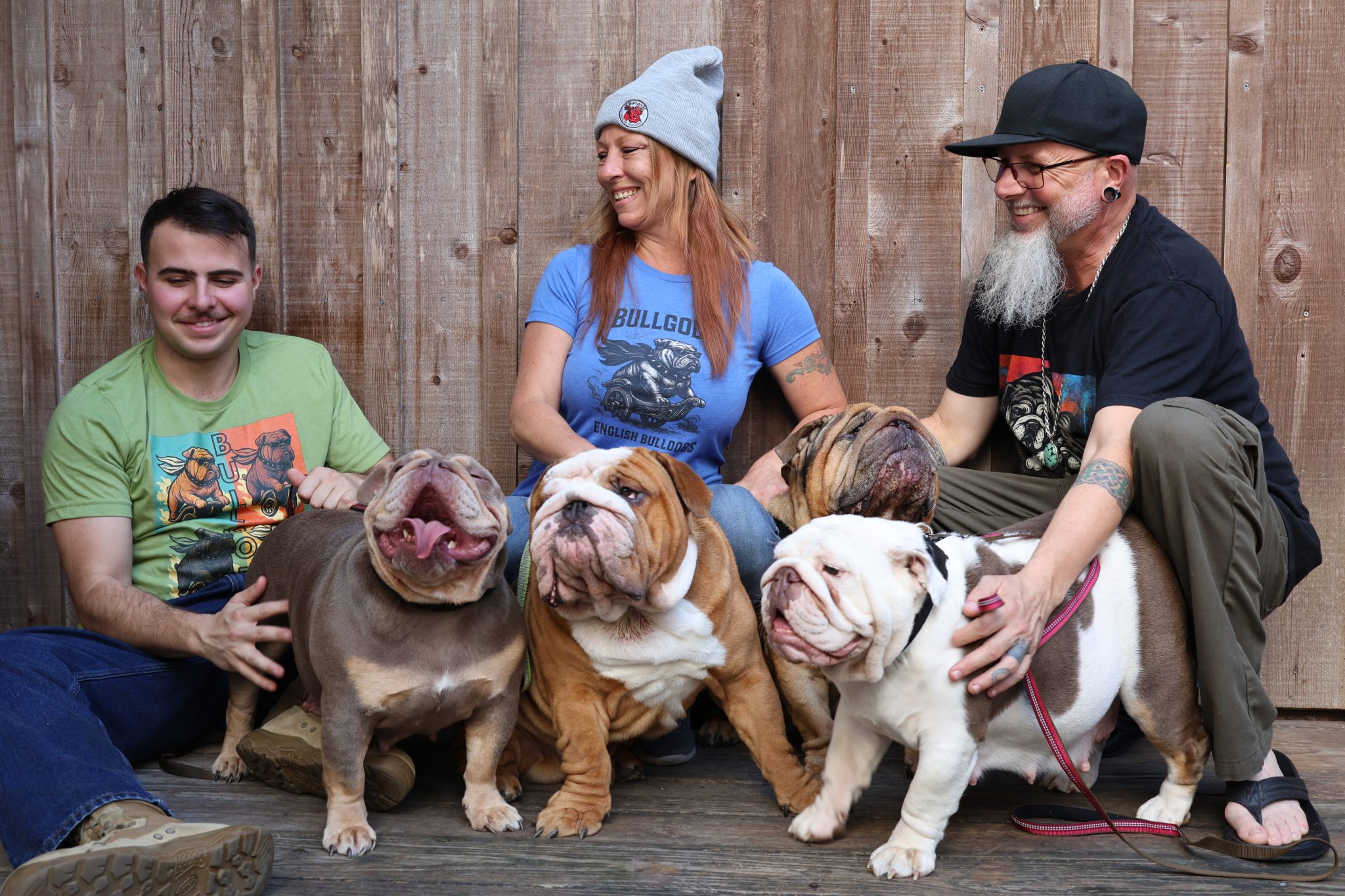 Members of the Bullgodz HQ family with their English Bulldogs, reflecting loyalty, experience, and responsible ownership