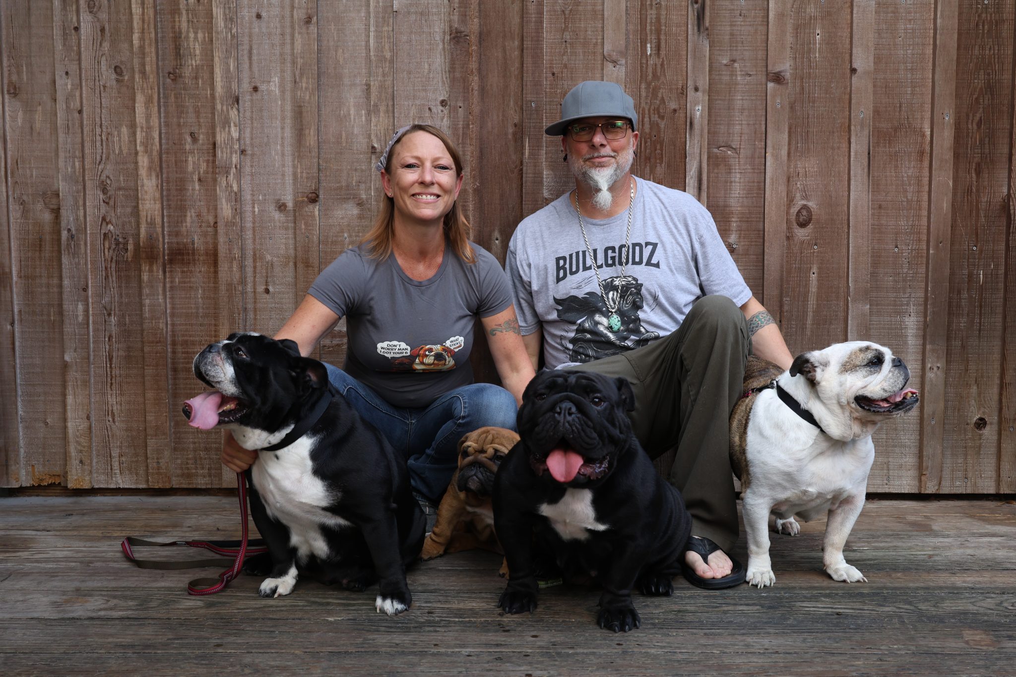 The Bullgodz HQ family surrounded by their English Bulldogs, showing the connection between people, dogs, and daily life